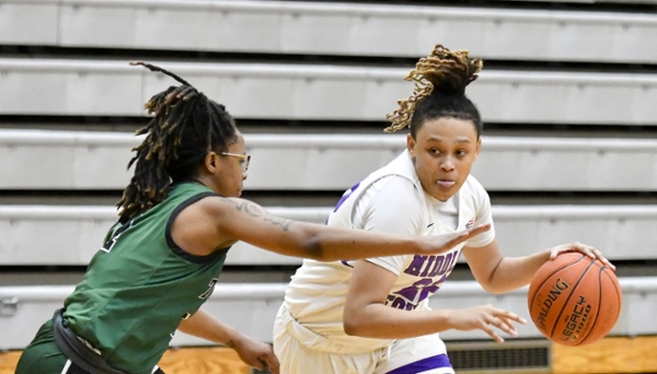 Knights women's basketball player dribbling the ball during a game. 